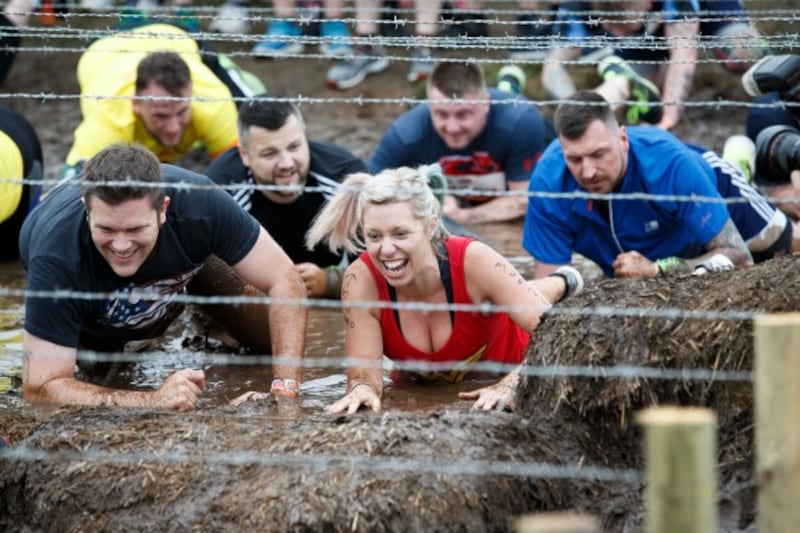 Participants take part in a Tough Mudder event race at Drumlanrig Castle