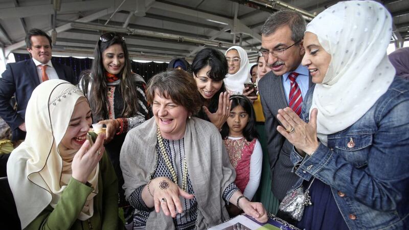 DUP leader Arlene Foster gets a henna tattoo from Syifaa Nabir at an event on the Boucher Road organised by the Belfast Islamic Centre yesterday. Picture by Mal McCann 