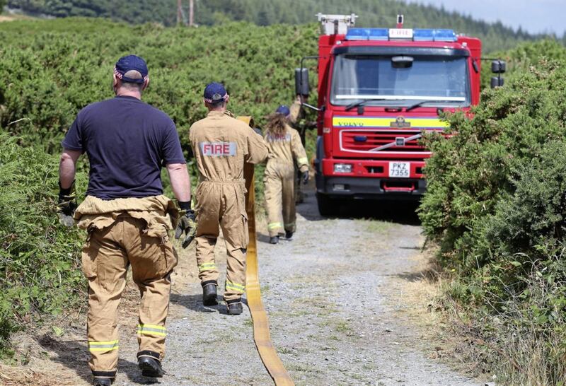 Firefighters tackle an ongoing gorse fire at Drinnahilly in Newcastle, walkers and hikers have been asked to stay away from Tollymore Forest Park near Newcastle in County Down. Picture Mal McCann. 