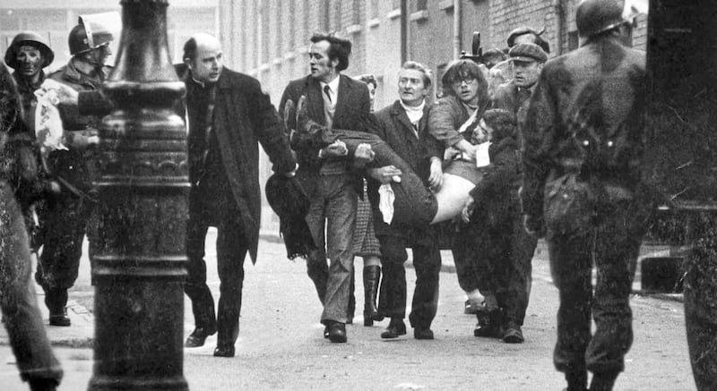 Former bishop of Derry Edward Daly leads a group carrying the dying Jackie Duddy from the Bogside on Bloody Sunday.