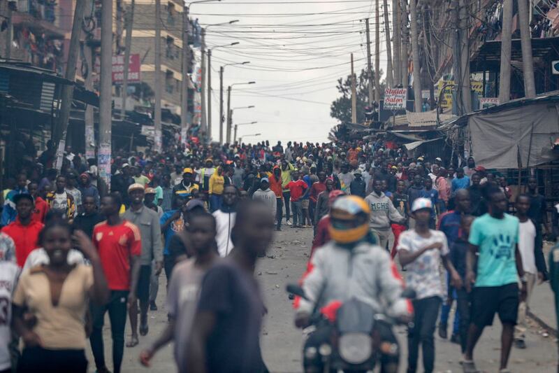 Protesters stand on the road during clashes in the Mathare area of Nairobi