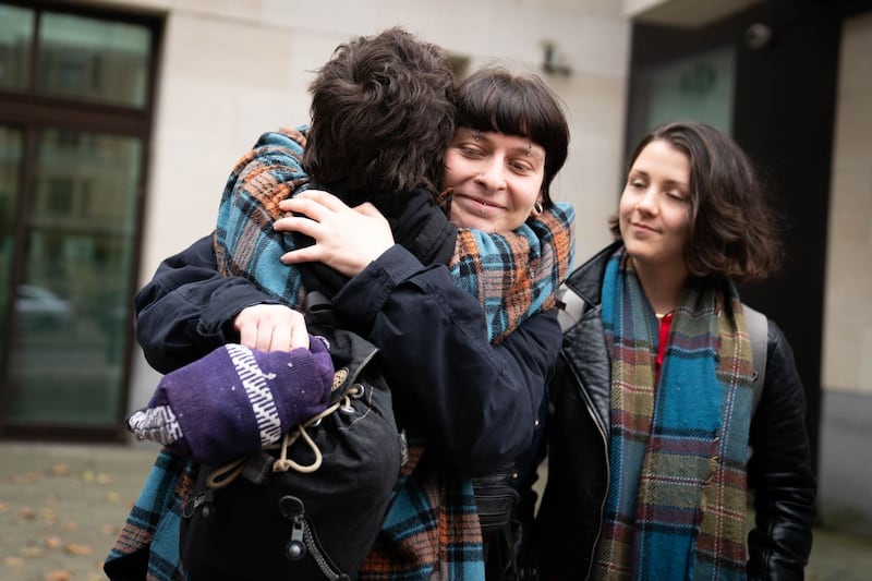 Hannah Taylor from Just Stop Oil hugs a supporter outside court