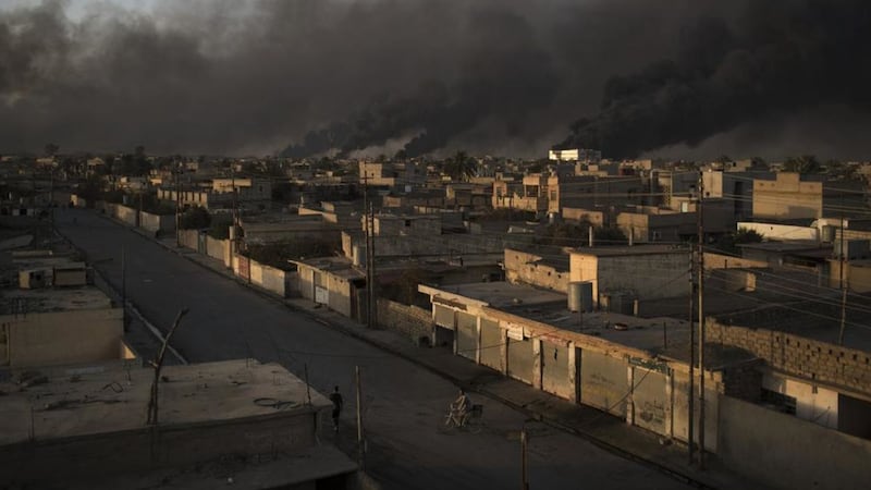 Smoke rises from burning oil fields in Qayara, some 50 kilometers south of Mosul, Iraq Felipe Dana/AP 