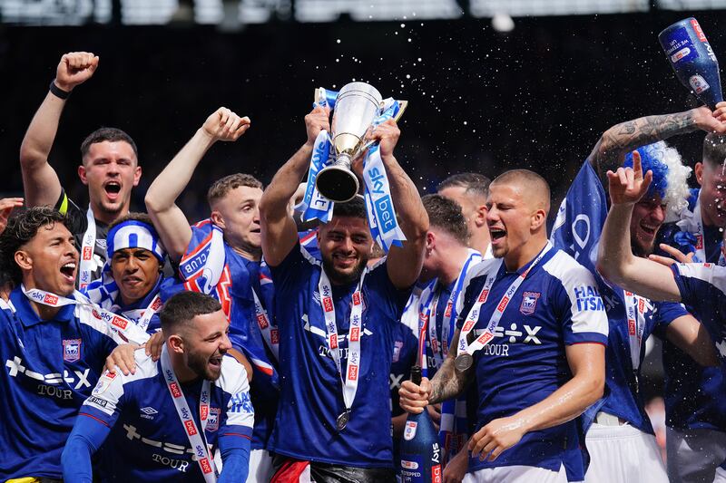Ipswich’s Sam Morsy celebrates with the trophy for promotion to the Premier League