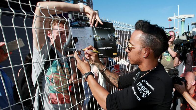 Lewis Hamilton signs autographs after putting pen to paper on a new contract in Monaco on Wednesday Picture: PA 