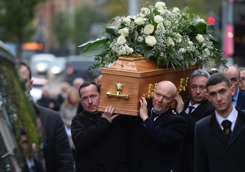 Fellow photographers carried the coffin of Hugh Russell following his funeral in Belfast. Picture by Mark Marlow