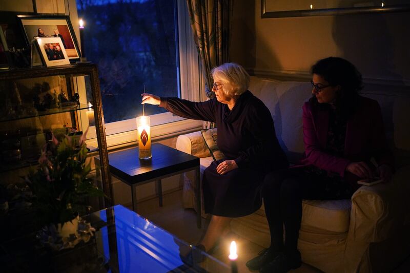 Holocaust survivor Joan Salter lights a memorial candle at her home in north London