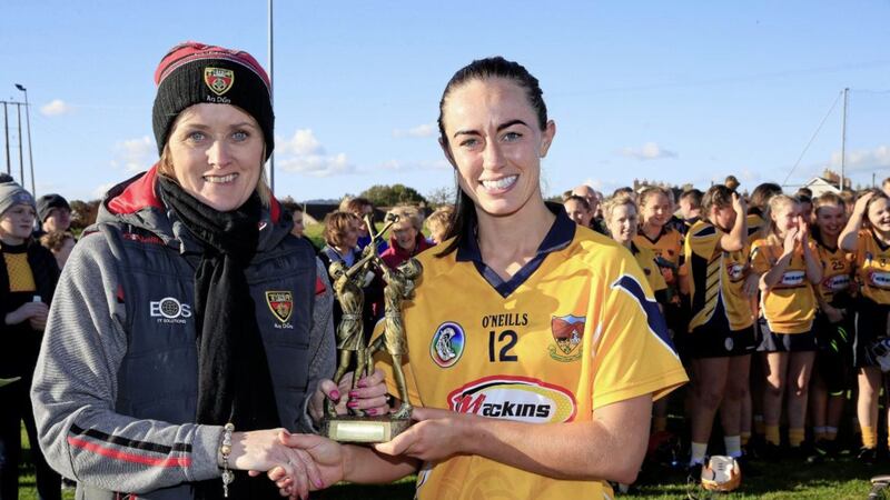 Clonduff Captain Paula O'Hagan receives the Player of the Match trophy from Mairead Rooney after the 2018 Down Camogie Final against Portaferry.<br /> Picture by Philip Walsh.