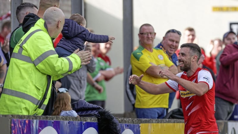 Cliftonville striker Joe Gormley celebrates with son Lorcan after scoring one of his two goals in the3-1 win over Dungannon Swifts at Stangmore Park in September. 