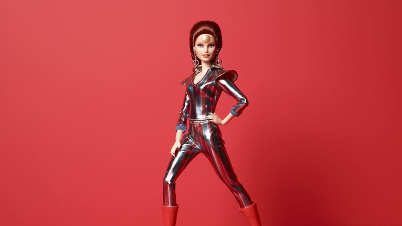 Barbie wears the metallic Ziggy space suit with red and blue stripes, flared shoulders and cherry red platform boots.