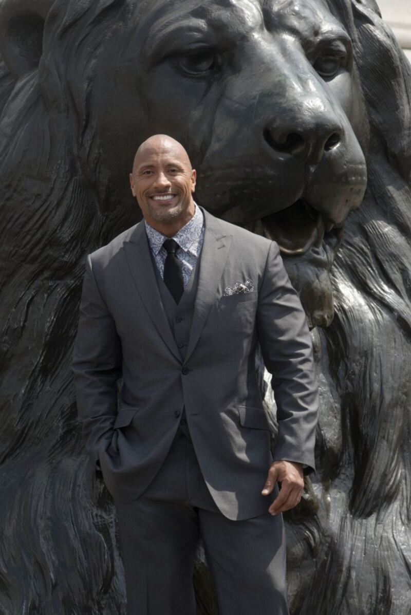 Dwayne Johnson aka The Rock poses with a lion in Trafalgar Square