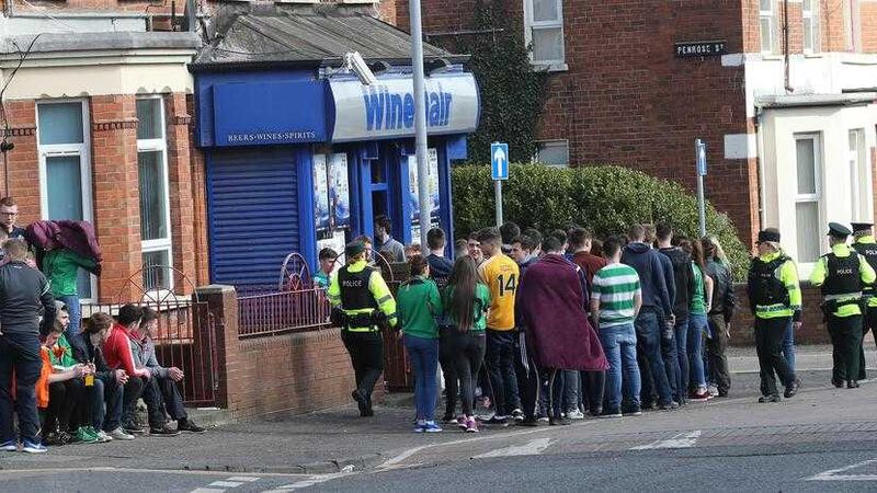 Young people queue outside an off licence in Belfast's Holylands area. Picture by Hugh Russell&nbsp;