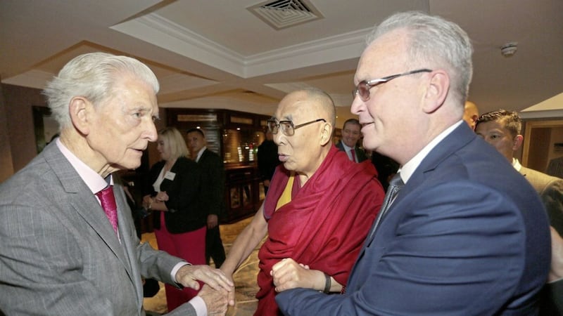 His Holiness the 14th Dalai Lama is greeted by members of the Children in Crossfire Board, including Jim Fitzpatrick together with Richard Moore at the Compassion in Action Conference lunch in Derry in 2017. Picture by Lorcan Doherty. 