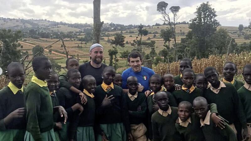 Sean Finn and Chris Kerr pictured with children at the `Plant the Planet Games&#39; with Self Help Africa in Kenya 