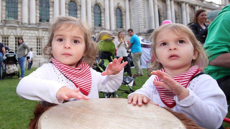 Twins Lilianna and Isabella McCabe, age two, from Ballygally, Co Antrim, enjoy a tribal drumming session for babies at Belfast City Hall Picture by Cliff Donaldson 