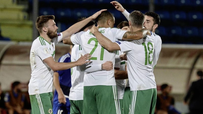 Josh Magennis is mobbed by team-mates after opening the scoring for Northern Ireland