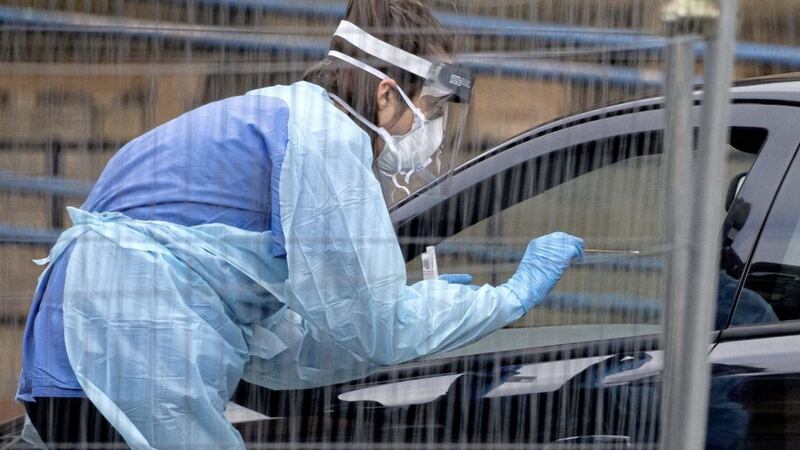 A nurse wears protective clothing at a drive through facility to test for coronavirus operating at Antrim Area Hosptial