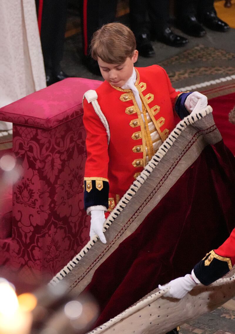 Prince George performs his duties at the coronation ceremony of his grandfather, the King