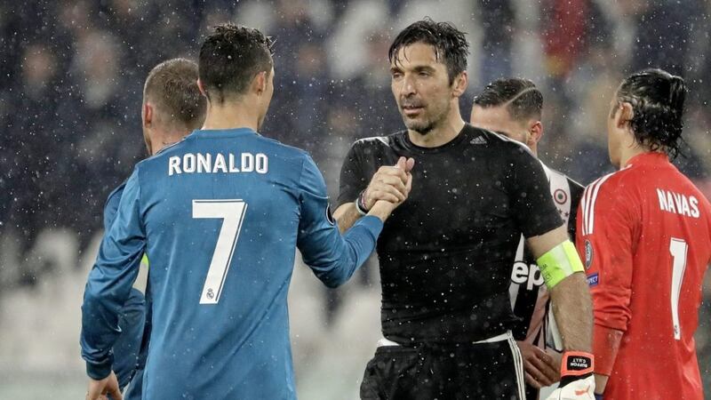 Juventus goalkeeper Gianluigi Buffon shakes hands with Real Madrid's Cristiano Ronaldo after the Champions League clash in Turin