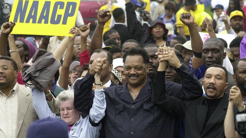 Jesse Jackson, centre, plans to step down from leading the Chicago civil rights organisation Rainbow PUSH Coalition (Mary Ann Chastain/AP/PA)