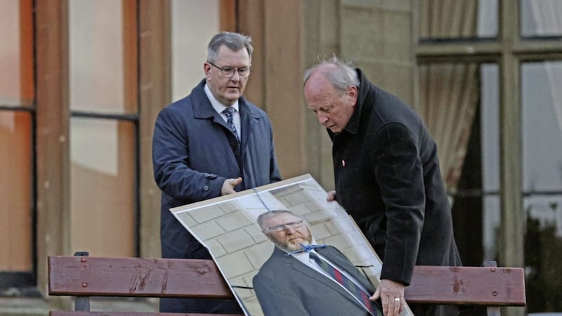 Jeffrey Donaldson and Jim LAllister remove a poster of Doug Beattie with a noose attached to it during an anti-protocol rally in Lurgan, Co Armagh, on Friday 