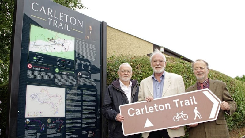 Actor Ian McElhinney, centre, with members of the William Carleton Summer School at the new panel at Clogher Primary School which marks start of the Carleton Trails 