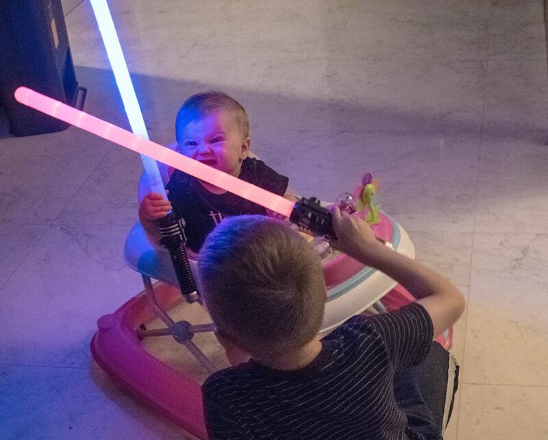 A baby with a lightsaber