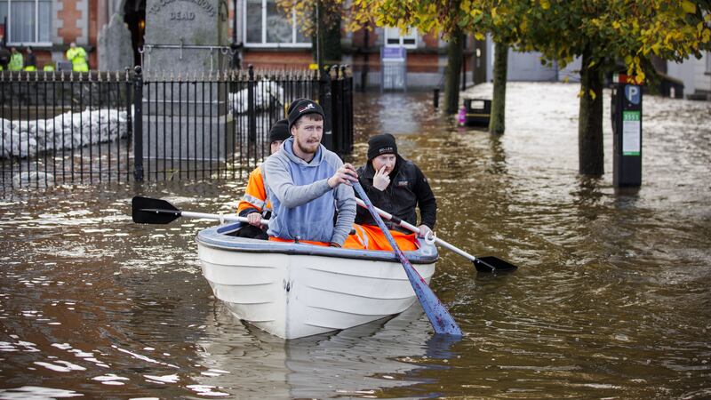 People canoe down a flooded Bank Parade in Newry Town, Co Down (Liam McBurney/PA)