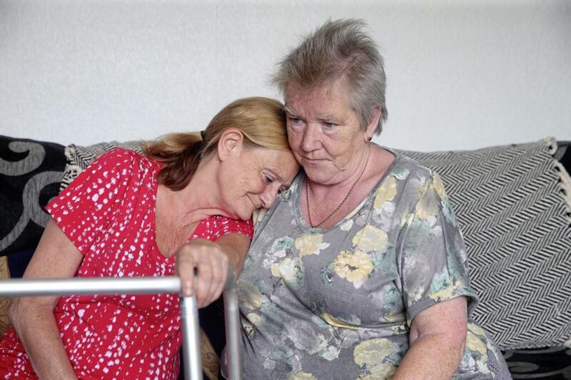 A tearful Anne Smith (left) with her friend and neighbour Marie Flynn before she handed herself in to authorities. Picture by Mal McCann