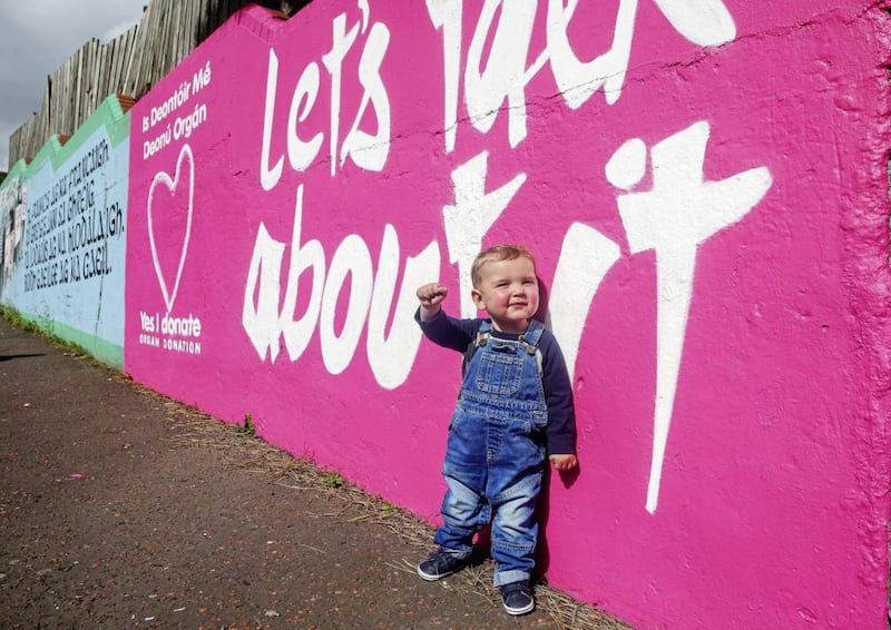 Daithi Mac Gabhann (2) at the new Organ donation mural on the Whiterock Road, Daithi is in need of an urgent heart transplant his parents M&Atilde;&iexcl;irt&Atilde;&shy;n Mac Gabhann and Seph N&Atilde;&shy; Mheall&Atilde;&iexcl;in have already convinced hundreds of people to sign the Organ and Tissue Donor register. Picture Mal McCann.. 