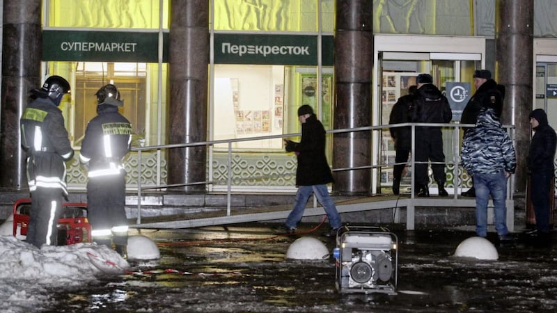 Police stand at the entrance of a supermarket after an explosion in St Petersburg, Russia. Picture by Dmitri Lovetsky/AP