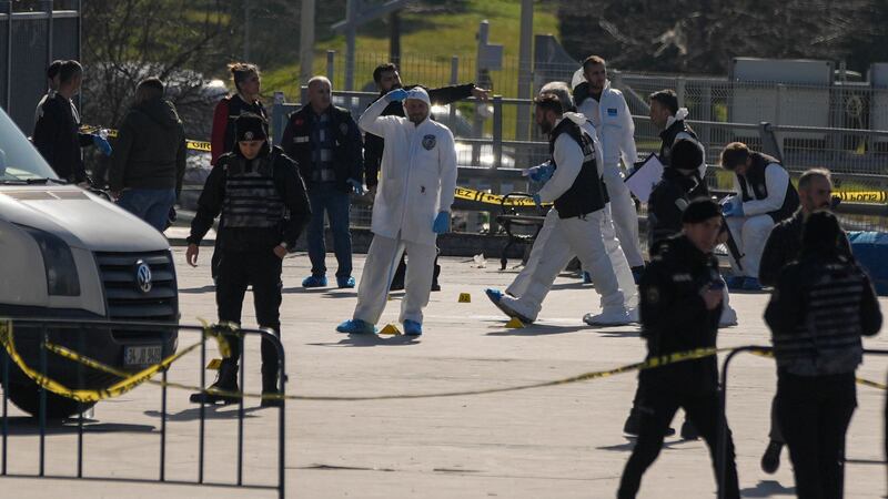 Security officers check the site where two attackers were killed (AP Photo/Francisco Seco)
