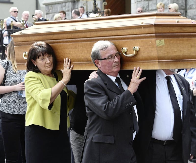 Anne Morgan helps carry the coffin of her brother and Disappeared victim Seamus Ruddy, who was laid in rest in Newry on Saturday. Mr Ruddy was abducted from Paris, killed and buried by the republican paramilitary group the INLA in 1985.Picture by Colm Lenaghan/Pacemaker 