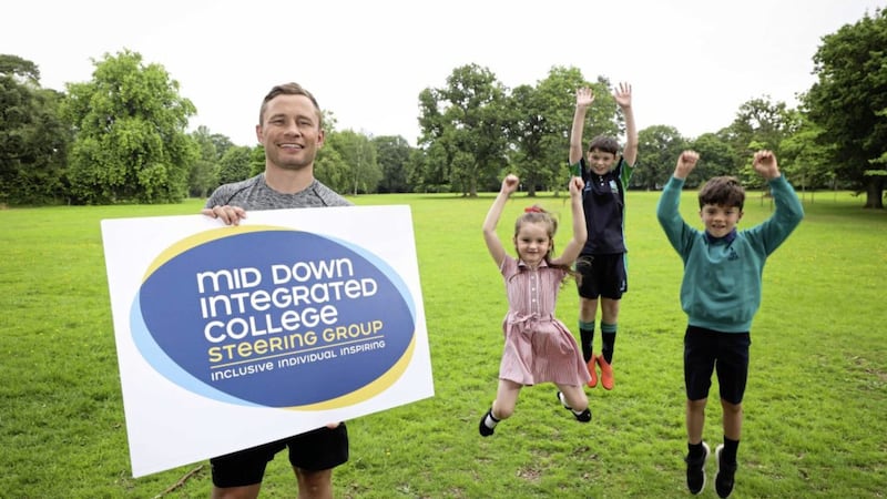 Carl Frampton with Elle Brown (5) of Cairnshill Primary School, Rafe McKervey (13) from Blackwater Integrated College and Felix Jackson (8) of Cedar Integrated Primary School as the boxing champion supports the establishment of a new integrated post primary school in the mid-Down area. 
