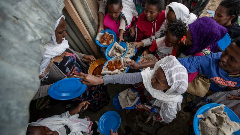 Displaced Tigrayans line up to receive food donated by local residents at a reception centre in Mekele, Ethiopia (AP Photo/Ben Curtis, File)