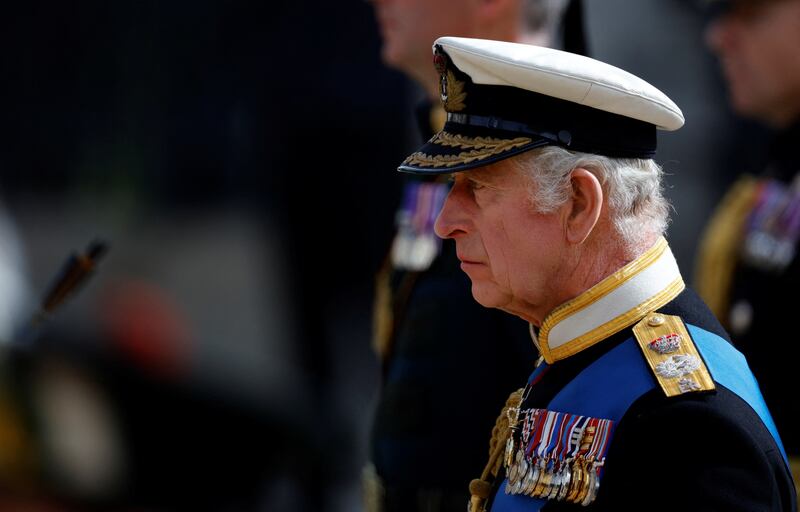 King Charles III follows the coffin of Queen Elizabeth II, draped in the Royal Standard with the Imperial State Crown and the Sovereign's orb and sceptre, as it leaves Westminster Abbey