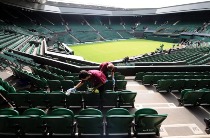 The seats in Centre Court are cleaned ahead of during day one of the 2011 Wimbledon Championships at the All England Lawn Tennis Club, Wimbledon.
