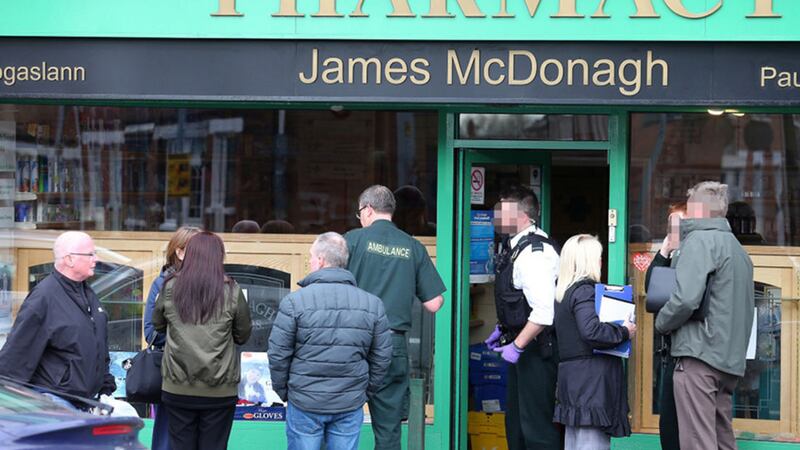 Forensic officers at a chemist on the Falls Road, Belfast where two people were stabbed during a robbery Picture Mal McCann&nbsp;