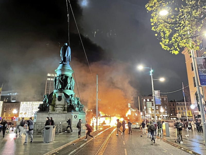 A bus and car on fire on O&#39;Connell Street in Dublin city centre on Thursday night. PICTURE: BRIAN LAWLESS/PA 