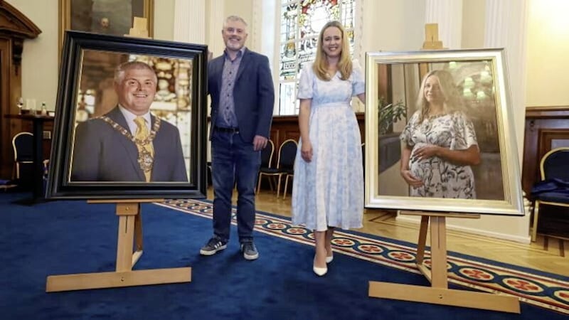 Former Alliance lord mayors of Belfast Michael Long and Kate Nicholl with their portraits 