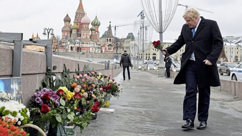 Britian&#39;s Foreign Secretary Boris Johnson adds to floral tributes at the site where opposition leader Boris Nemtsov was shot dead on a bridge near Red Square in Moscow PICTURE: Stefan Rousseau/PA 