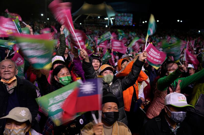 Supporters cheer for the Democratic Progressive Party during an elections rally in New Taipei City (Ng Han Guan/AP)