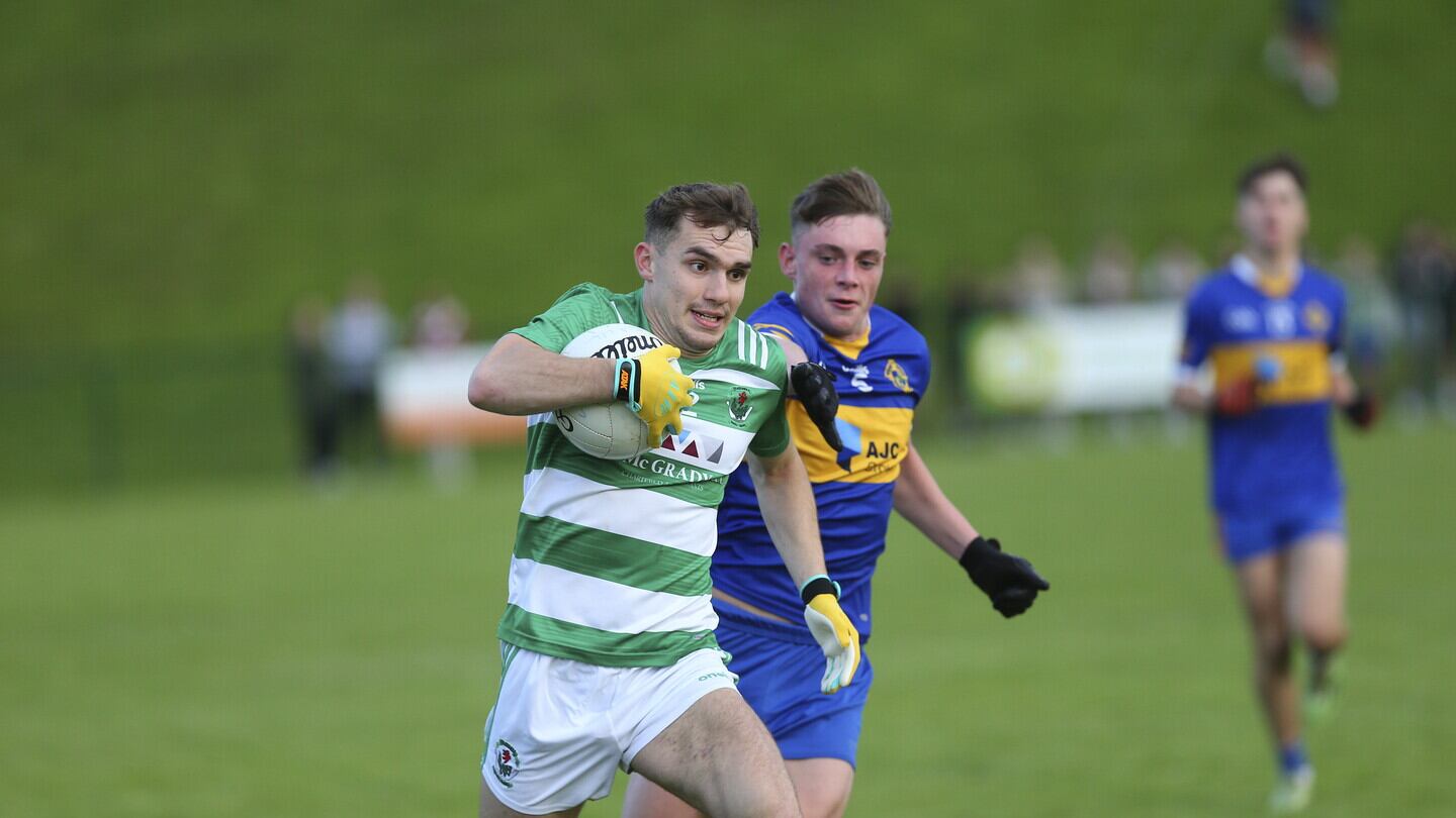 Downpatrick's Tom Smyth gets clear of Odhran Magee of Saul during Thursday night's Down SFC first round tie at Darragh Cross     Picture: Louis McNally