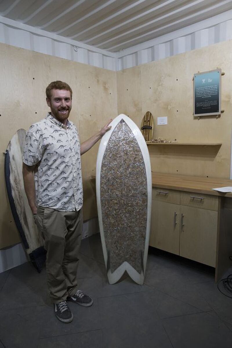 Lane with his cigarette-covered surf board.