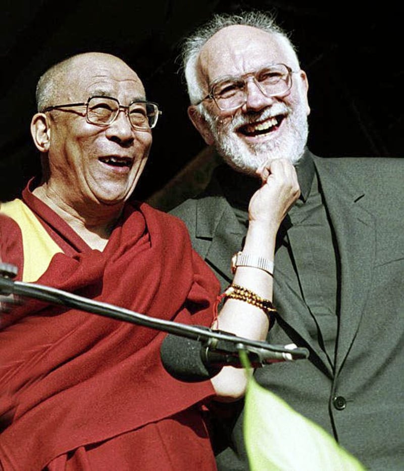 Father Gerry Reynolds from Clonard Monastery has his beard pulled by the Dalai Lama in west Belfast