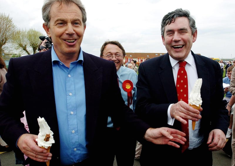 Tony Blair hands Gordon Brown a ’99’ ice cream during a visit to a park (Peter Nicholls/PA)