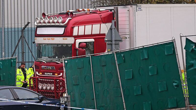 &nbsp;Two officials remove their hats and bow their heads as a&nbsp;container lorry inside which 39 people were found dead inside leaves Waterglade Industrial Park in Grays, Essex, heading towards Tilbury Docks under police escort. Picture by&nbsp;Victoria Jones/PA Wire