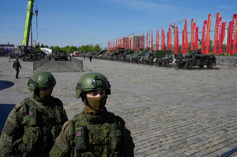 Russian soldiers guard a display in Moscow of armoured military vehicles that belonged to the Ukrainian army (Alexander Zemlianichenko/AP)