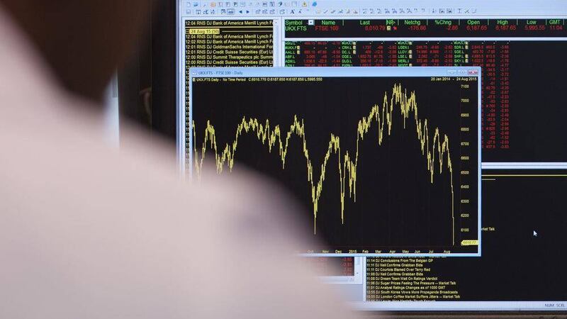 AN office worker views a graph showing yesterday&#39;s movement in the FTSE 100 Index, as it fell by as much as 190 points to dip below the 6,000-mark for the first time in more than two and a half years PICTURE: Lauren Hurley/PA 