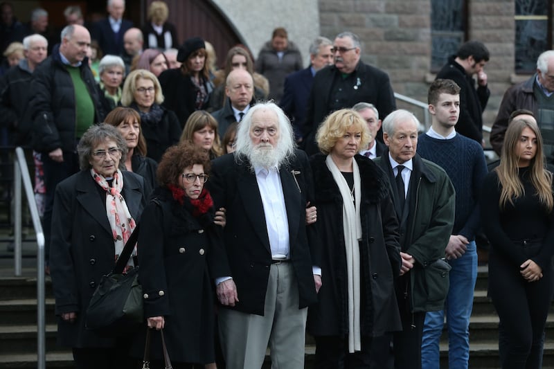 Therese MacGowan's husband Maurice, centre, is comforted by family members at her funeral in Co Tipperary&nbsp;